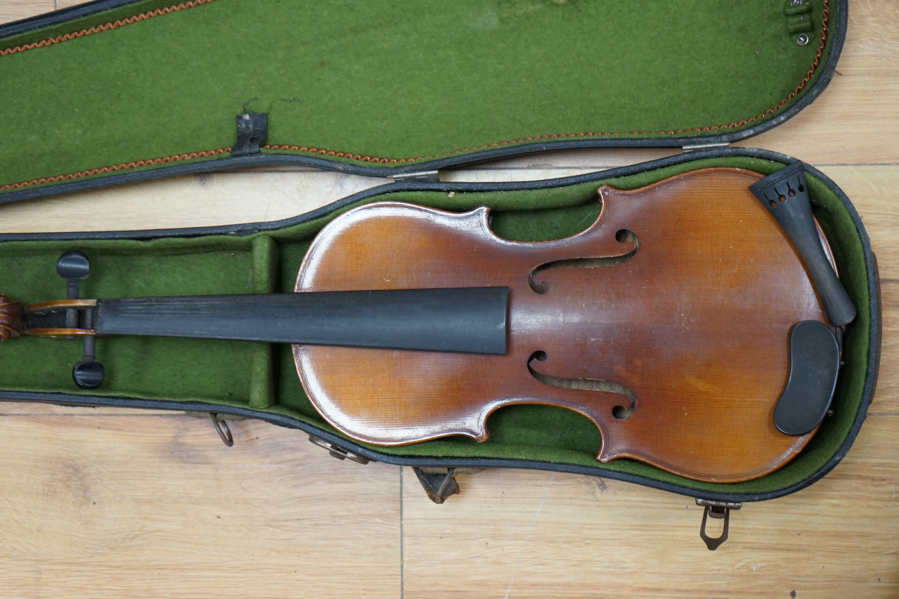 A cased three-quarter size 1920s Czechoslovakian violin, body length 33cm. Condition - fair to good.